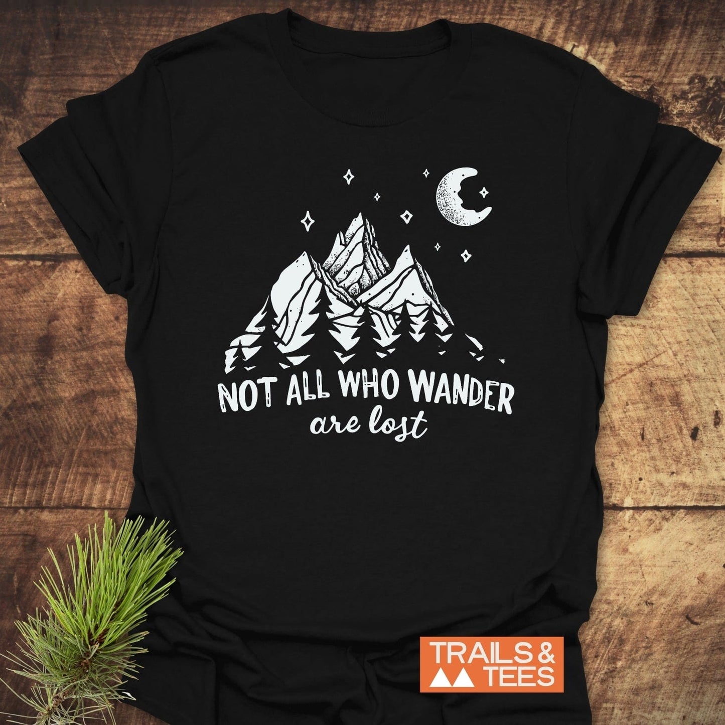 Not All Who... Nightsky T-Shirt featuring a mountain and pine graphic with a crescent moon, offering trail-tested comfort in lightweight, durable cotton.