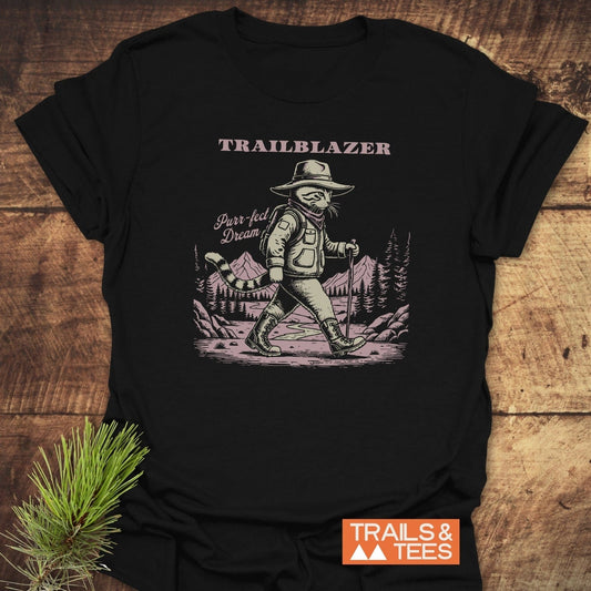Purr-fect Dream Hiking T-Shirt with cat hiker graphic, 'TRAILBLAZER' text. Soft, durable cotton; pre-shrunk for fit. Ideal for outdoor enthusiasts.