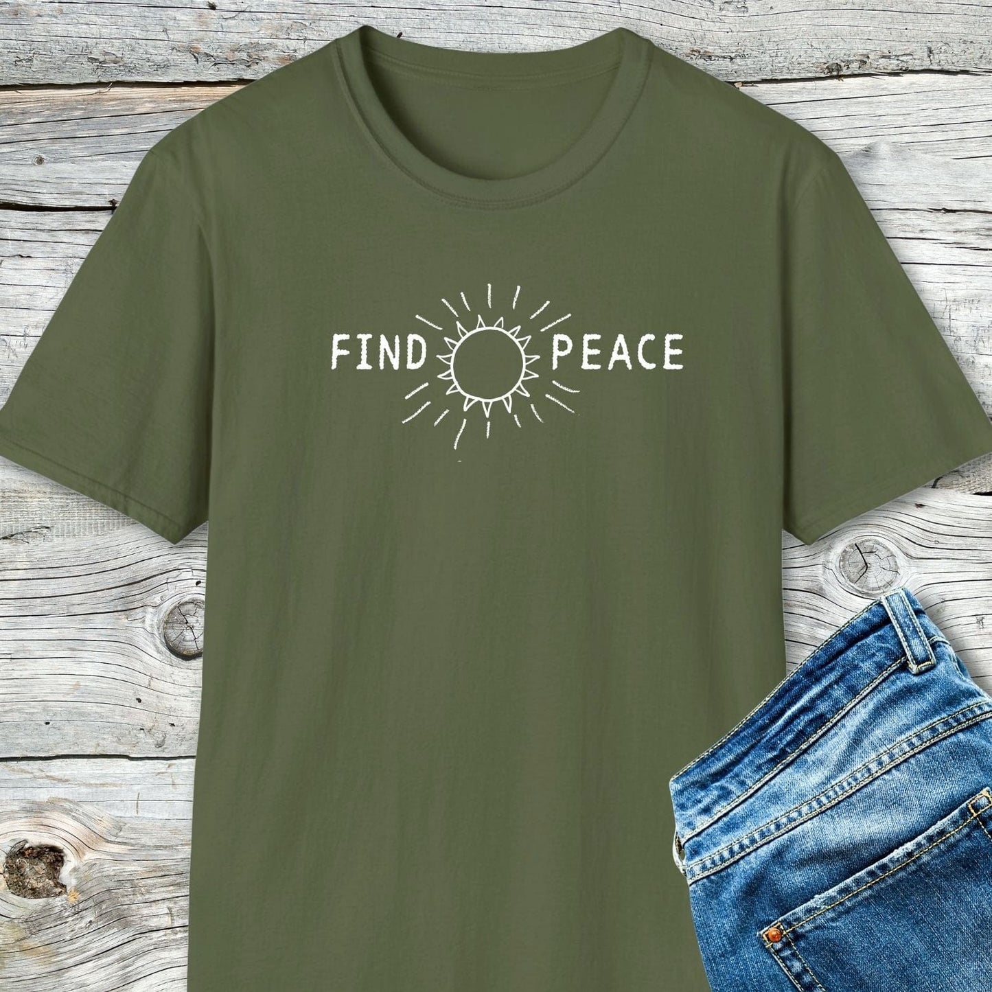 Find Peace T-Shirt in olive-green with white “FIND PEACE” text and sun graphic, paired with blue jeans; crafted from soft, ring-spun cotton for comfort.