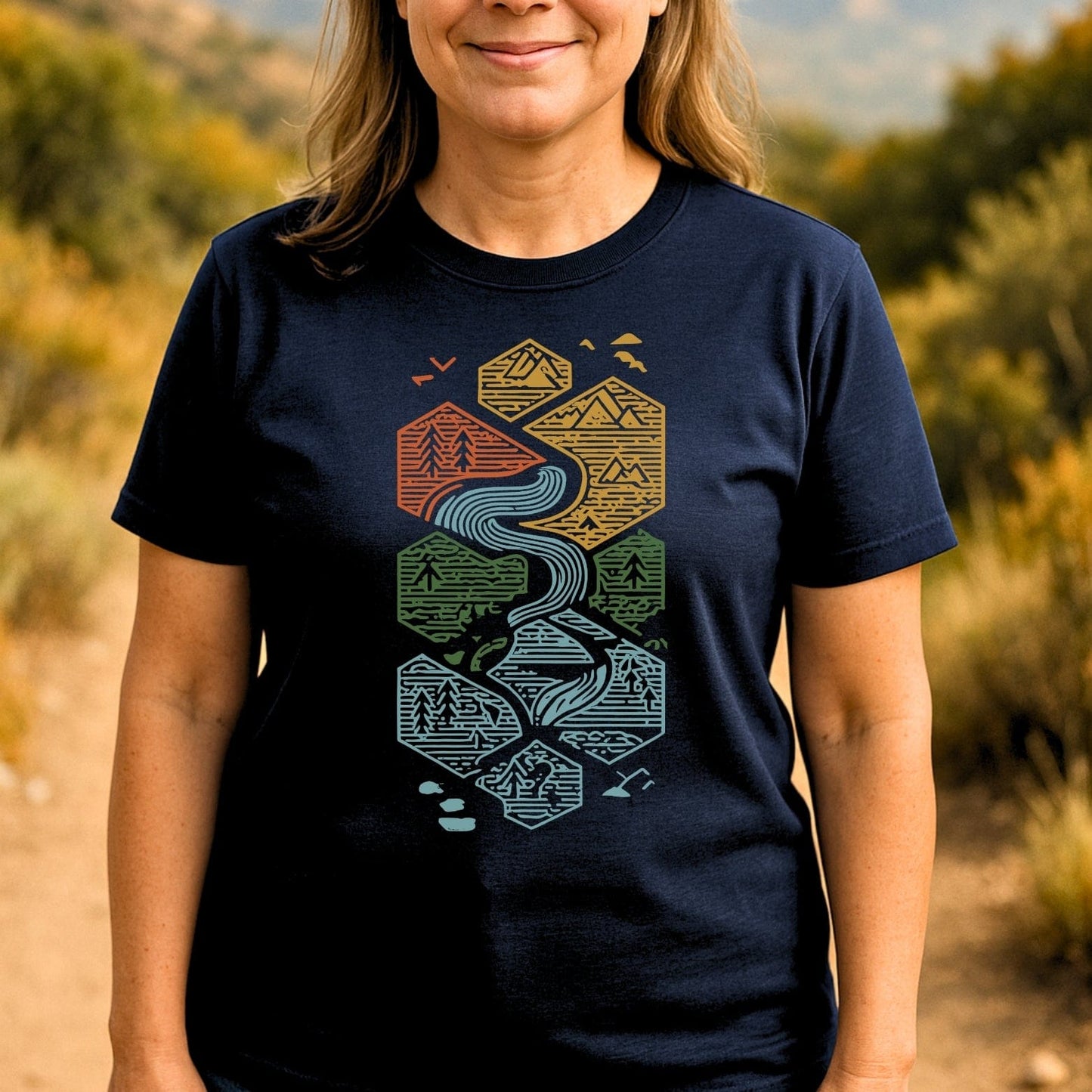 Person wearing Everything Flows T-Shirt with stylized hexagon nature scenes; crafted from soft cotton, ideal for outdoor adventures, printed on demand for sustainability.