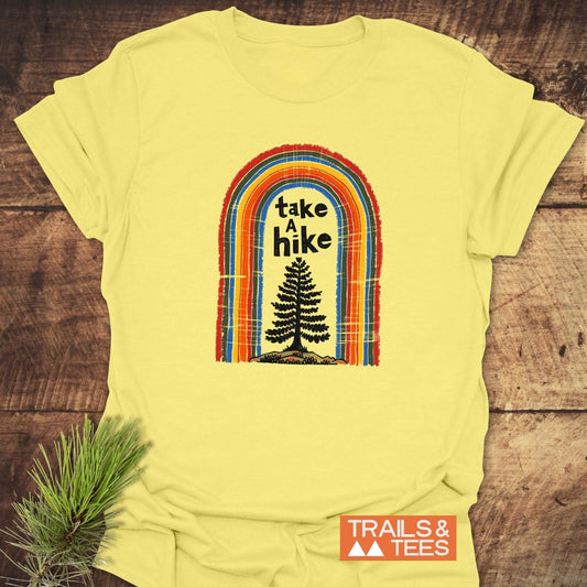 Take A Hike Rainbow T-Shirt featuring a retro rainbow arch and tree silhouette, crafted from soft, lightweight cotton for outdoor adventures and everyday comfort.
