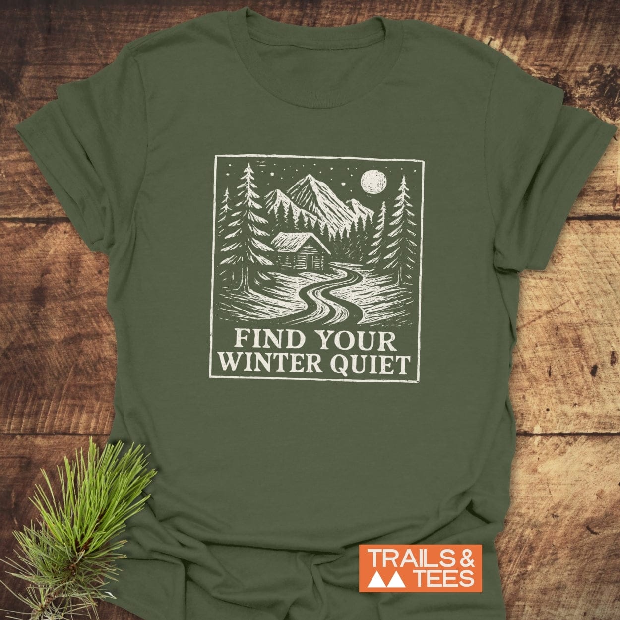 Find Your Winter Quiet Cabin T-Shirt featuring a snowy mountain scene with a full moon and slogan, perfect for outdoor enthusiasts seeking comfort and adventure.