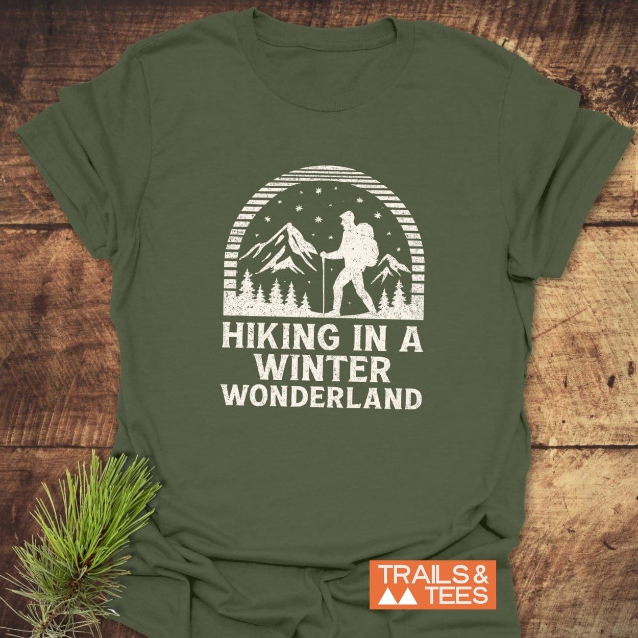 Hiking In A Winter Wonderland T-Shirt featuring a winter hiking scene and slogan, crafted from soft cotton with durable prints, perfect for outdoor enthusiasts.