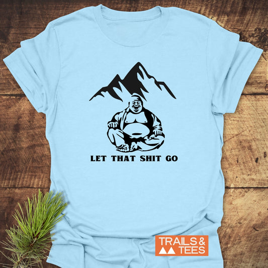 Let That Sh*t Go Funny T-Shirt featuring a black graphic of a laughing Buddha with mountain peaks, slogan beneath, and a Trails & Tees logo, highlighting adventure-ready comfort and durable prints.