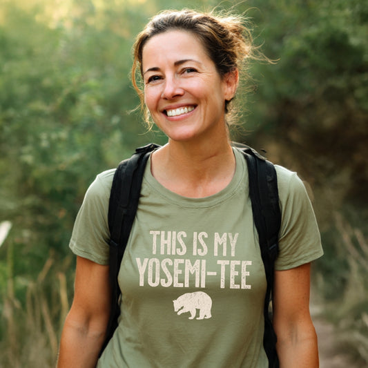 Woman on a hike wearing the This Is My Yosemi-Tee Funny T-Shirt, showcasing its bear silhouette design. The tee is crafted for outdoor comfort, perfect for adventure enthusiasts.