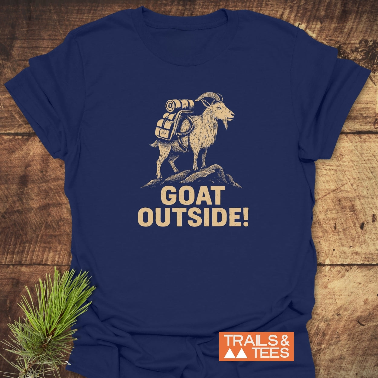 Goat Outside! Funny T-Shirt featuring a bearded mountain goat with gear on a rocky outcrop and 'GOAT OUTSIDE!' slogan, crafted for comfort and adventure with durable prints and sustainable design.