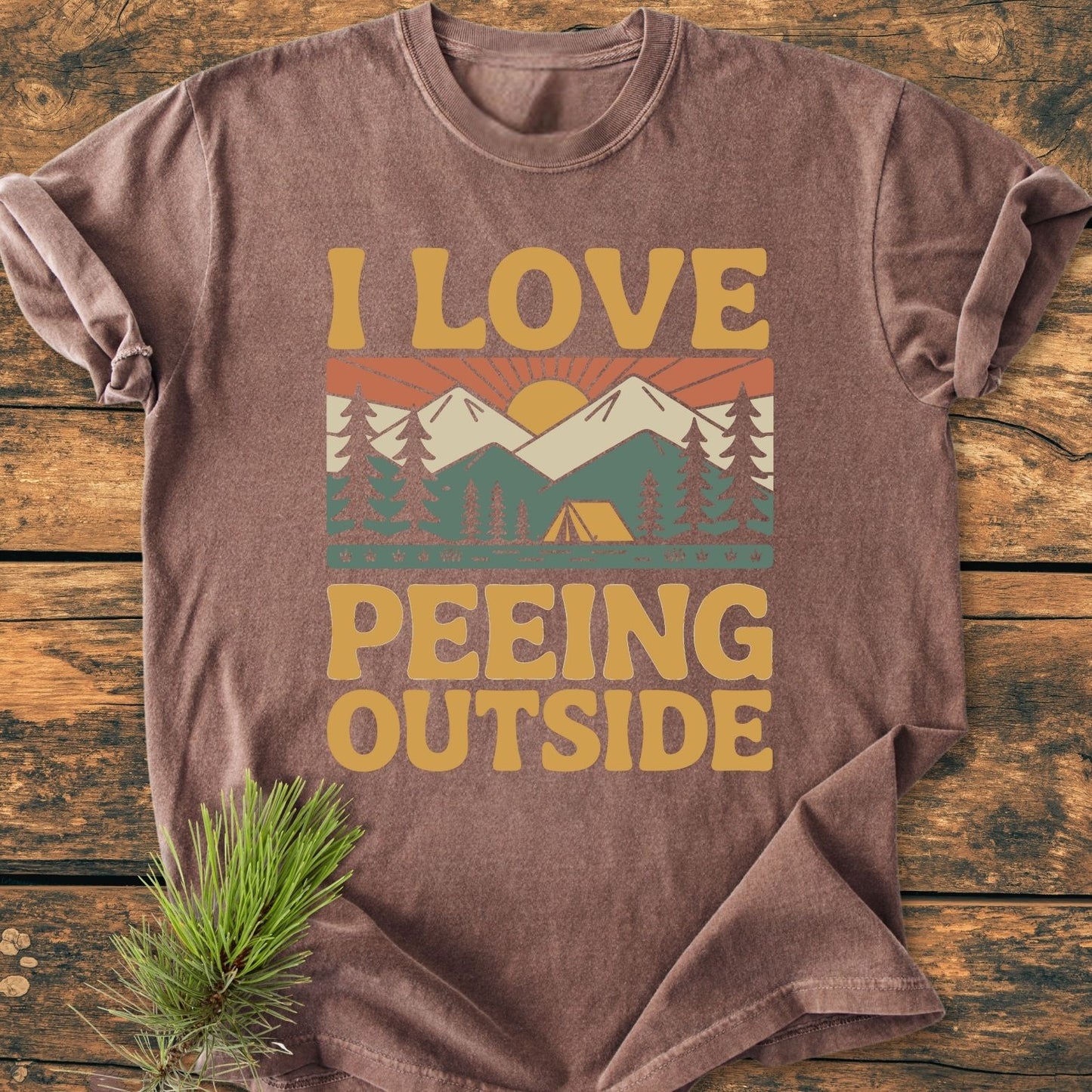 I Love Peeing Outside - Vintage Wash Tee features a brown, short-sleeved design with a humorous outdoors scene print, made from soft, garment-dyed, 100% ring-spun cotton, offering a relaxed, durable fit.