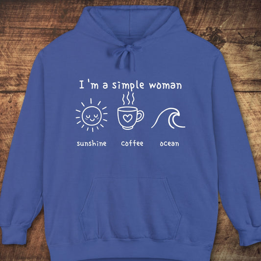 The I'm A Simple Woman - Sunshine Coffee Ocean Hoodie features white line drawings of a sun, coffee mug, and wave on a blue sweatshirt, offering a relaxed unisex fit with a vintage look.