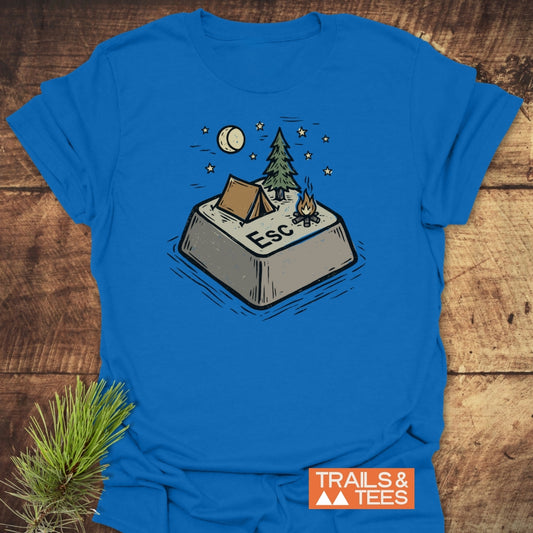 Escape T-Shirt featuring a campsite-themed Esc key illustration with a tent, tree, campfire, and stars. Labeled TRAILS & TEES in orange, emphasizing outdoor adventure and comfort.