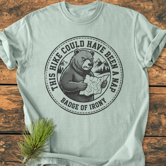 Could Have Been A Nap - Vintage Wash Tee features an annoyed bear with a map graphic on a comfy, relaxed-fit T-shirt, perfect for daily wear. The shirt lies on a wooden surface.