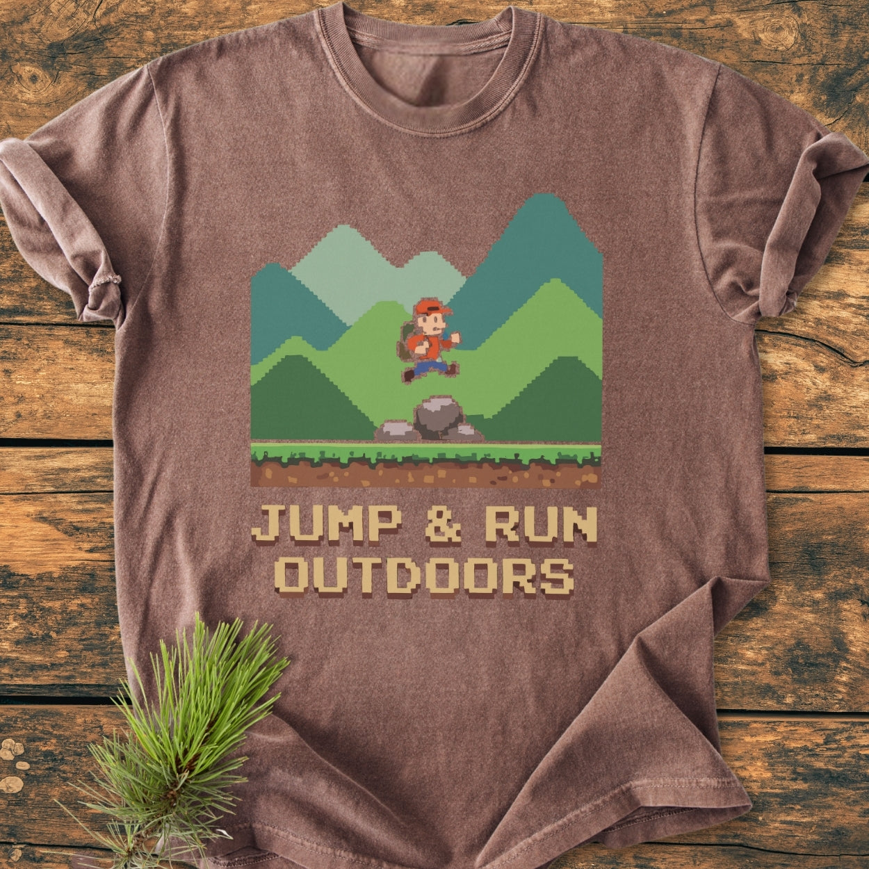 Jump And Run Outdoors - Vintage Wash Tee features a pixel-art hiker design, showcasing retro gaming style on soft, brown fabric, perfect for outdoor enthusiasts seeking comfort and durability.