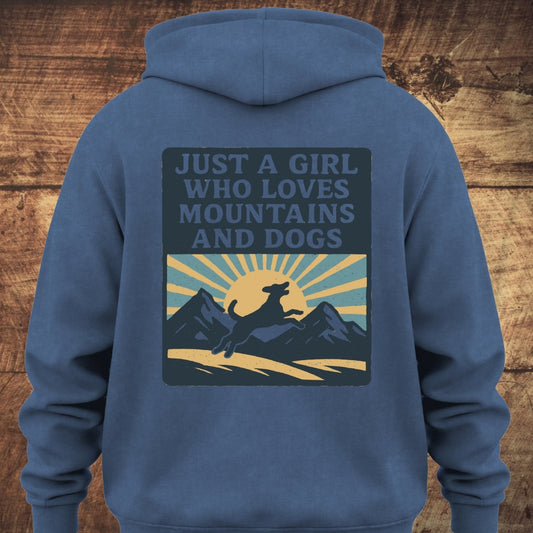 Back view of the Just A Girl Who Loves Dogs Hoodie BACKPRINT featuring a mountain, sunrise, and dog silhouette graphic. The hoodie offers a relaxed fit, ideal for outdoor activities.