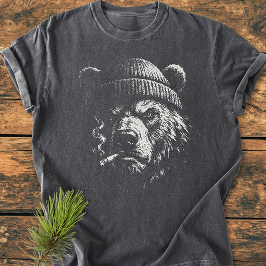 Smoking Bear - Vintage Wash Tee features a charcoal-gray T-shirt with a grizzly bear illustration wearing a beanie and holding a cigarette, showcasing its relaxed fit and soft-washed, garment-dyed cotton fabric.