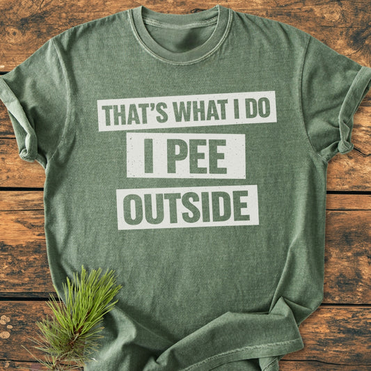 Green That's What I Do. I Pee Outside - Vintage Wash Tee laid on wood, features bold slogan with pine sprig accent. Made of soft, durable 100% ring-spun cotton with a relaxed fit.