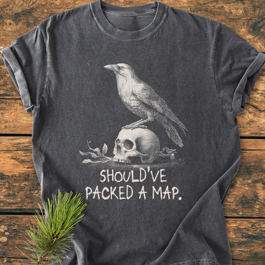 No WI-FI - Vintage Wash Tee: Dark-gray, short-sleeve with a white crow and skull illustration, text below. Laid on rustic wood with pine sprig, showcasing Comfort Colors' relaxed, cozy, and durable design.