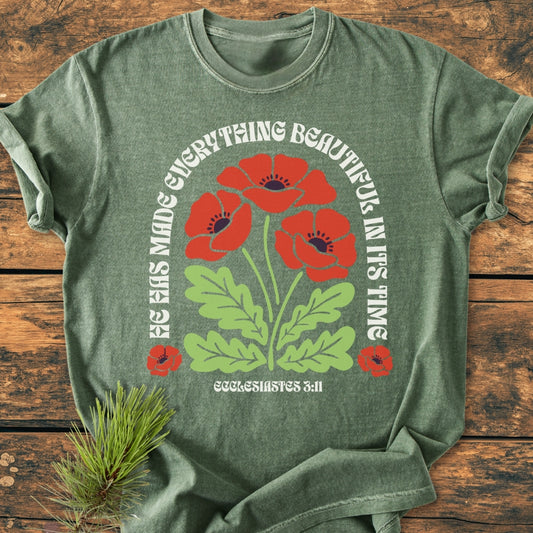 He Has Made Everything Beautiful - Vintage Wash Tee: Heather-green tee with red poppies and quote from Ecclesiastes 3:11, styled with a pine twig, showcasing Comfort Colors' soft, durable fabric.