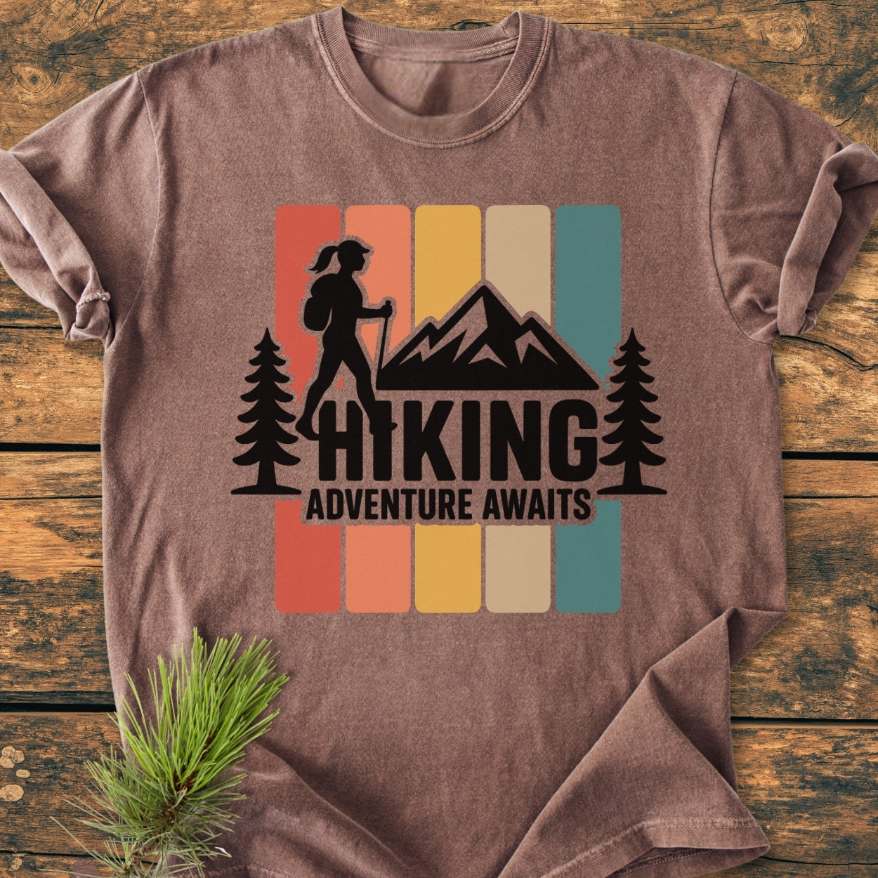 Hiking Girl - Vintage Wash Tee features a retro graphic of a hiker silhouette with mountains and trees, set against five color blocks. Made from soft, durable, garment-dyed cotton for comfort.