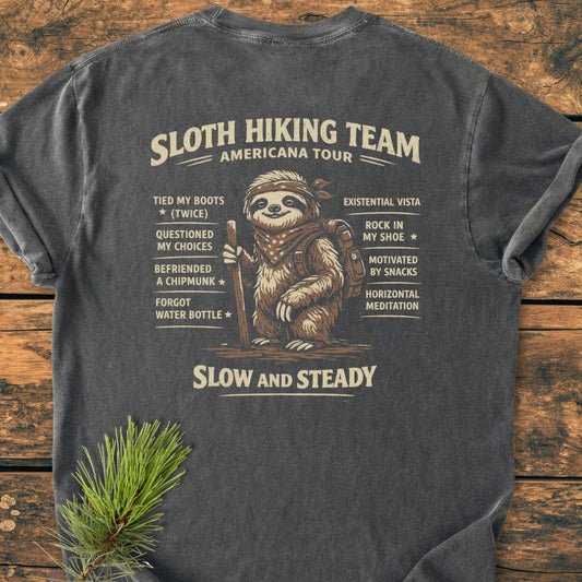Sloth Hiking Team Tour BACK PRINT - Vintage Wash Tee featuring a cartoon sloth with a bandana and backpack, surrounded by humorous hiking bullet points, emphasizing a relaxed, playful outdoor spirit.