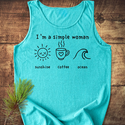 I'm A Simple Woman - Sunshine Coffee Ocean Tank Top features teal fabric with black text/icons: sun, coffee, wave. Evergreen sprig on shirt. Made from sustainable, ring-spun US cotton for relaxed fit.