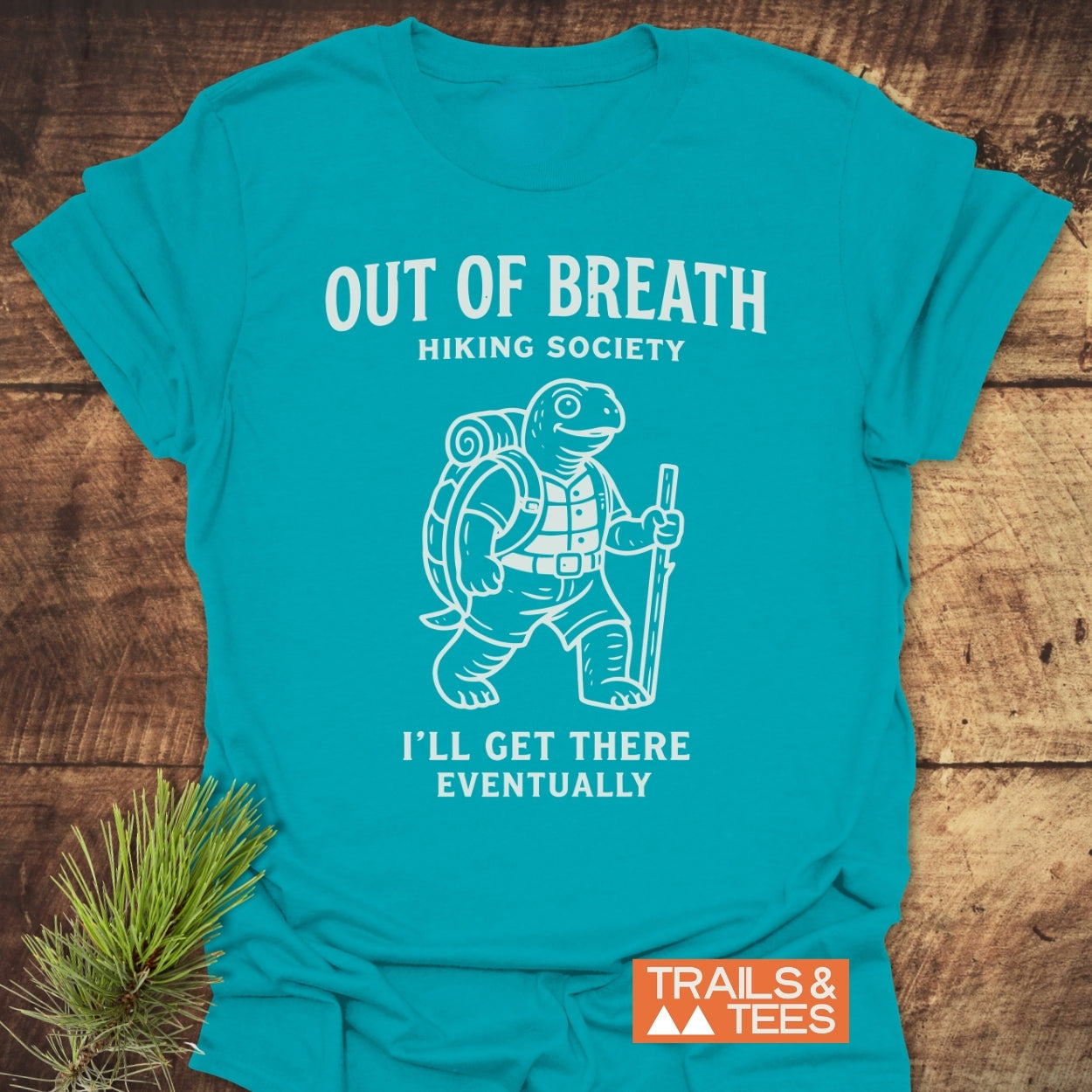 Out Of Breath Turtle T-Shirt featuring a hiking tortoise with a backpack and walking stick, captioned I'll Get There Eventually, designed for comfort and adventure enthusiasts.