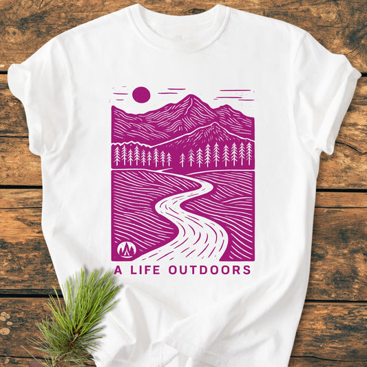 A Life Outdoors - Vintage Wash Tee features a purple outdoor scene with mountains, trees, and a river, on a white, soft-washed, garment-dyed T-shirt, highlighting comfort and durability.