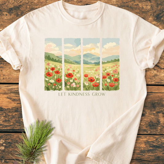 Let Kindness Grow - Vintage Heavyweight Tee featuring a five-panel stylized landscape with poppies, hills, and sky, centered phrase, laid on wood, highlighting garment-dyed, relaxed fit, 100% ring-spun cotton design.