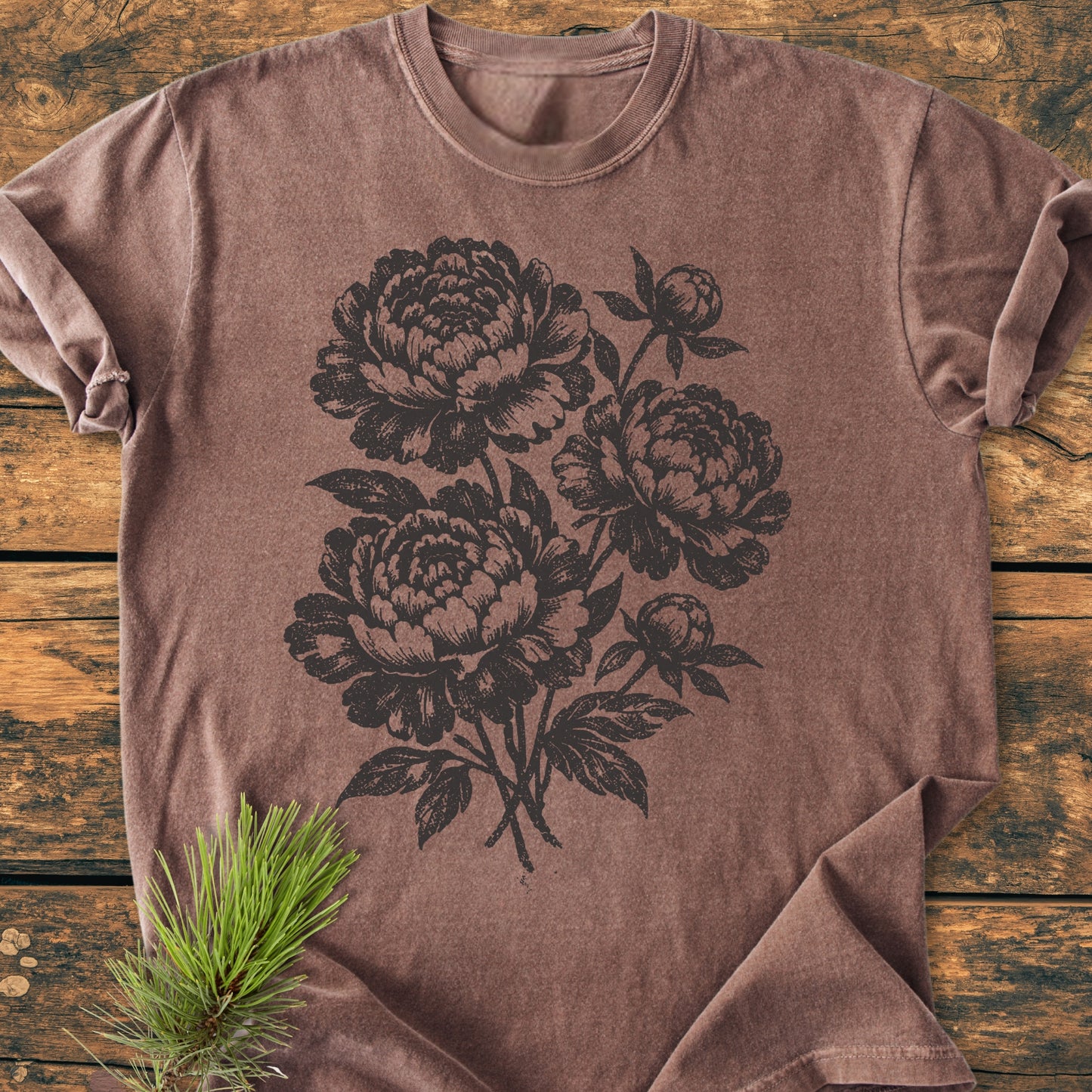 Peony Bouquet - Vintage Heavyweight Tee features a black botanical peony print on a brown crew-neck, showcasing the soft, relaxed fit of this 100% ring-spun cotton, garment-dyed tee.