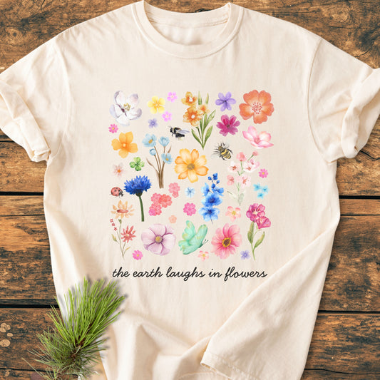 The Earth Laughs In Flowers - Vintage Heavyweight Tee features watercolor-style botanical illustrations with insects on light-cream fabric, enhancing its cozy, relaxed fit and durable construction.