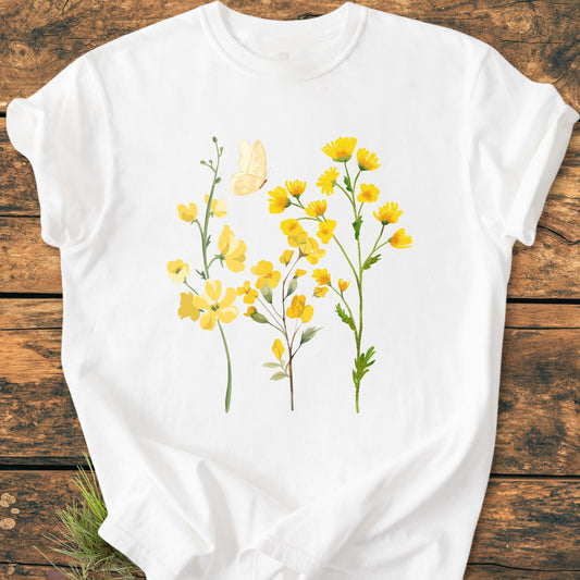 Yellow Boho Flowers - Vintage Heavyweight Tee featuring a nature-inspired graphic of yellow wildflowers and a butterfly, displayed on a wooden surface, highlighting its relaxed fit and durable craftsmanship.