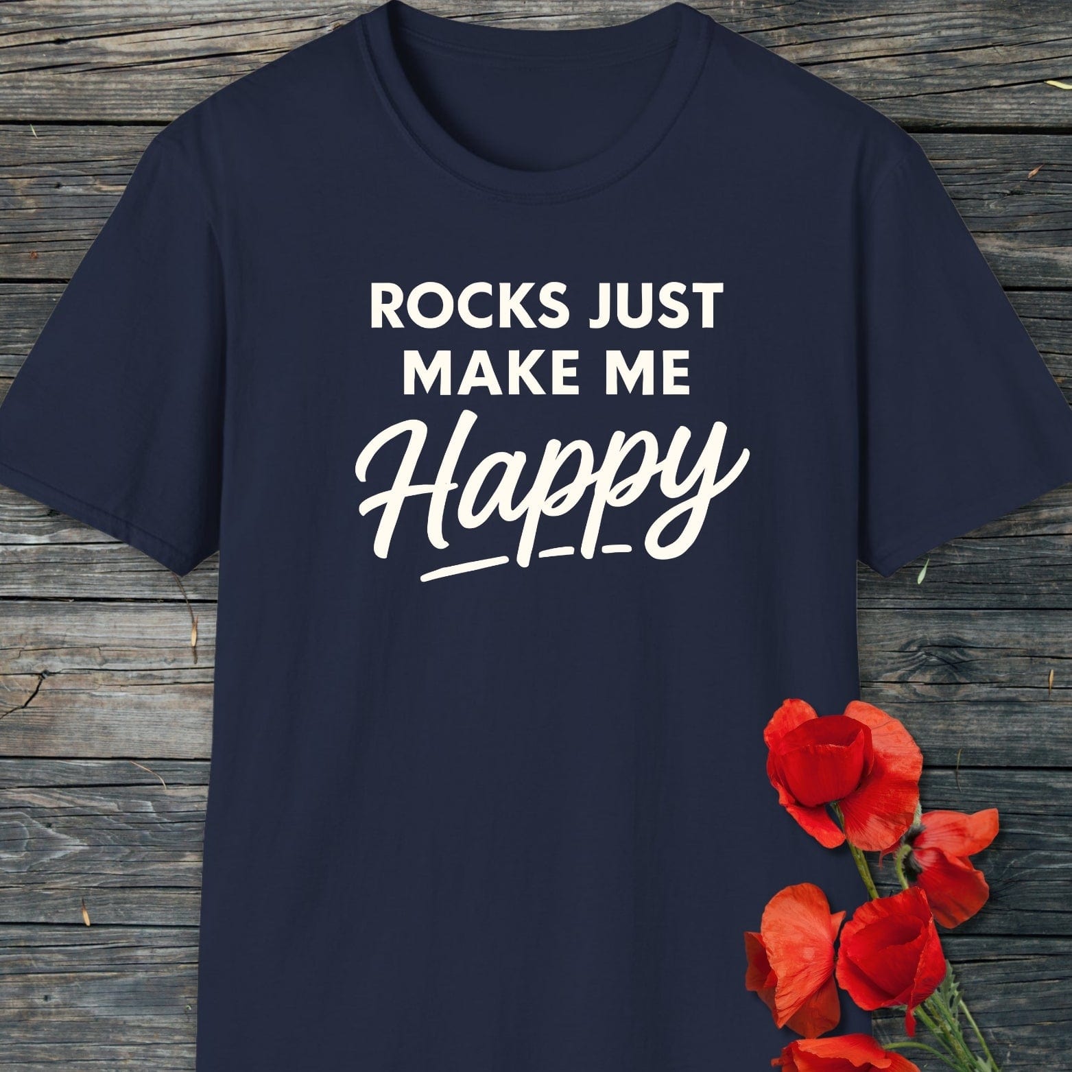 Navy-blue Rocks Make Me Happy T-shirt with white lettering, adorned with red poppy accents, highlighting outdoor comfort and durability for adventure enthusiasts.
