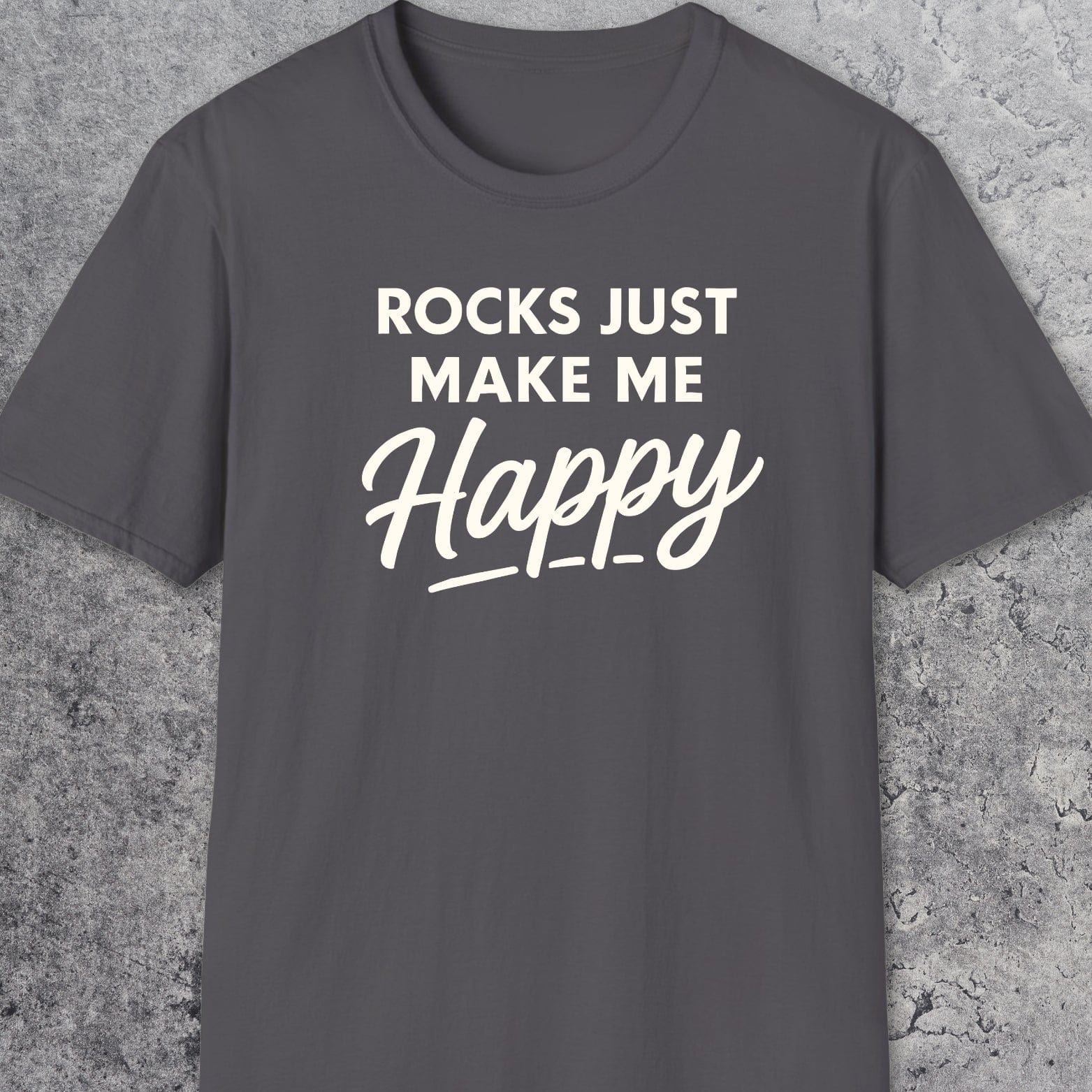 Rocks Make Me Happy T-Shirt with white lettering on charcoal-gray fabric, showcasing comfort and adventure-ready design, crafted from soft, lightweight ring-spun cotton.