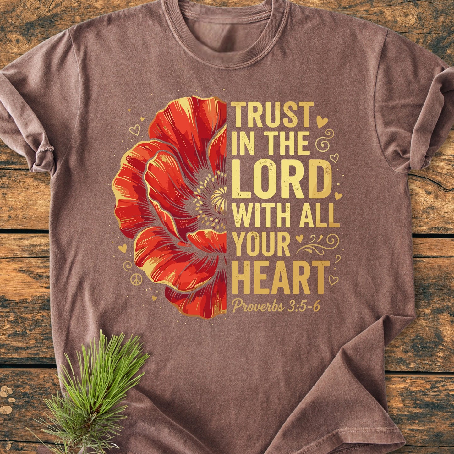 Trust In The Lord - Vintage Wash Tee featuring a red poppy graphic with yellow scripture text, hearts, and swirls. Laid flat, showcasing its relaxed fit and soft, garment-dyed fabric.