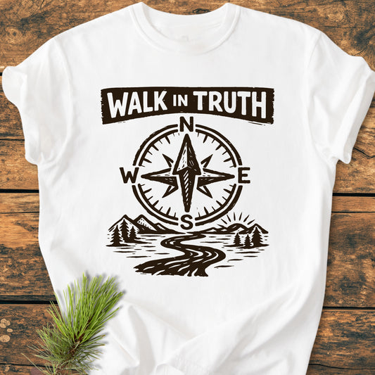 Walk In Truth 3 John 1,4 - Vintage Wash Tee features a compass rose and scenic landscape design, laid on wood with a pine sprig, showcasing its durable, relaxed-fit, garment-dyed cotton fabric.
