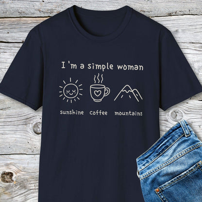 I'm A Simple Woman - Sunshine Coffee Mountains T-Shirt showcasing line-art icons with text, laid beside jeans. Soft, lightweight, unisex fit for everyday comfort.
