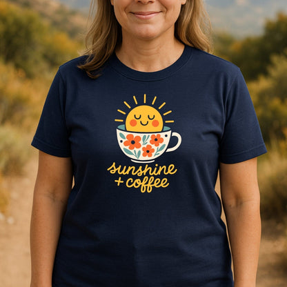Sunshine And Coffee T-Shirt featuring a smiling sun rising from a floral coffee cup with text sunshine + coffee, perfect for adventures and everyday comfort.