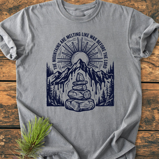 Heather-gray T-shirt featuring 1414 Mountains Melting Like Wax design with a sunburst, melting mountains, evergreen trees, and a cairn. Arched text completes the vintage, nature-inspired graphic.