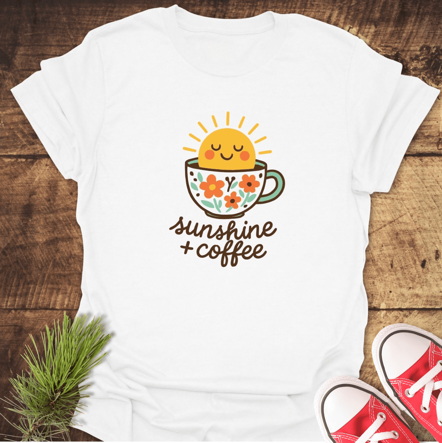 Sunshine And Coffee T-Shirt featuring a floral coffee cup and smiling sun graphic, perfect for adventures. Soft, lightweight cotton ensures comfort and durability.