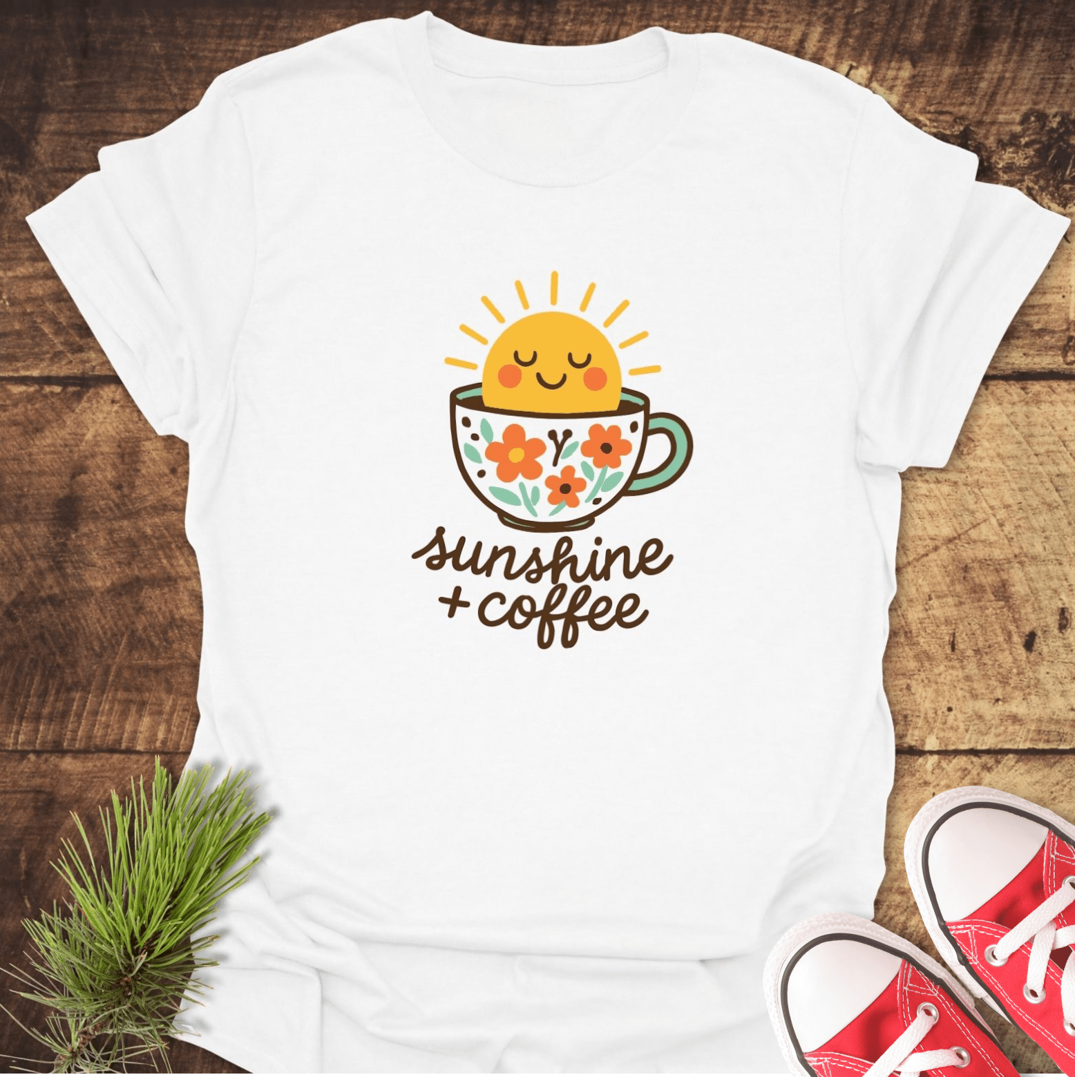 Sunshine And Coffee T-Shirt featuring a floral coffee cup and smiling sun graphic, perfect for adventures. Soft, lightweight cotton ensures comfort and durability.