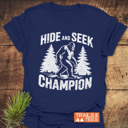 Hide And Seek Champion T-Shirt featuring a prominent Bigfoot graphic, designed as an active shirt, perfect for casual wear.