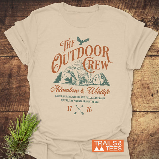 The Outdoor Crew Vintage T-Shirt on a table, showcasing its durable DTF prints and soft ring-spun cotton, designed for outdoor enthusiasts.