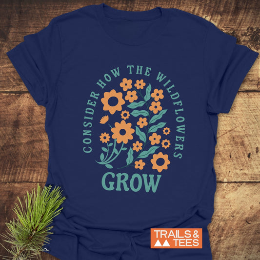 Wildflowers Luke 12:27 T-Shirt featuring orange flower pattern, crafted from soft ring-spun cotton for comfort, ideal for outdoor adventures with durable, fade-resistant print.