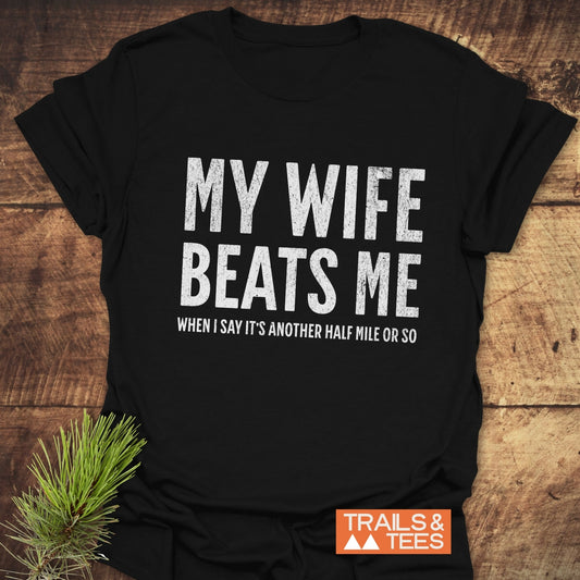 My Wife Beats Me T-Shirt; lightweight, ring-spun cotton tee with durable prints, designed for comfort and outdoor adventures, featuring taped shoulders and no side seams.