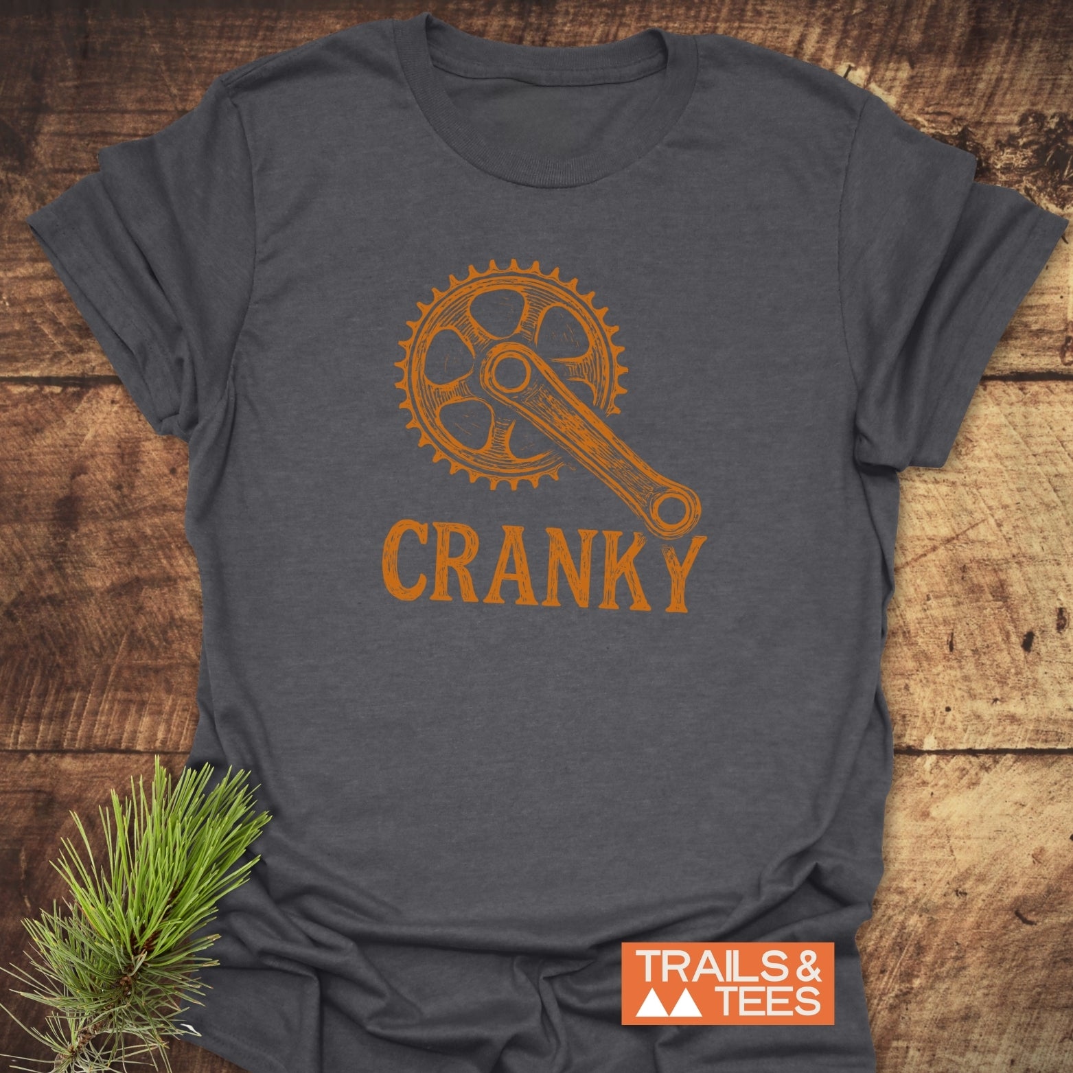 CRANKY T-Shirt featuring a dynamic orange design, showcasing its short sleeves and active wear style in a close-up view.
