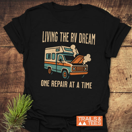 Living The RV Dream T-Shirt featuring bold white text on a black shirt, ideal for active and casual wear, embodies the adventurous spirit of RV life.