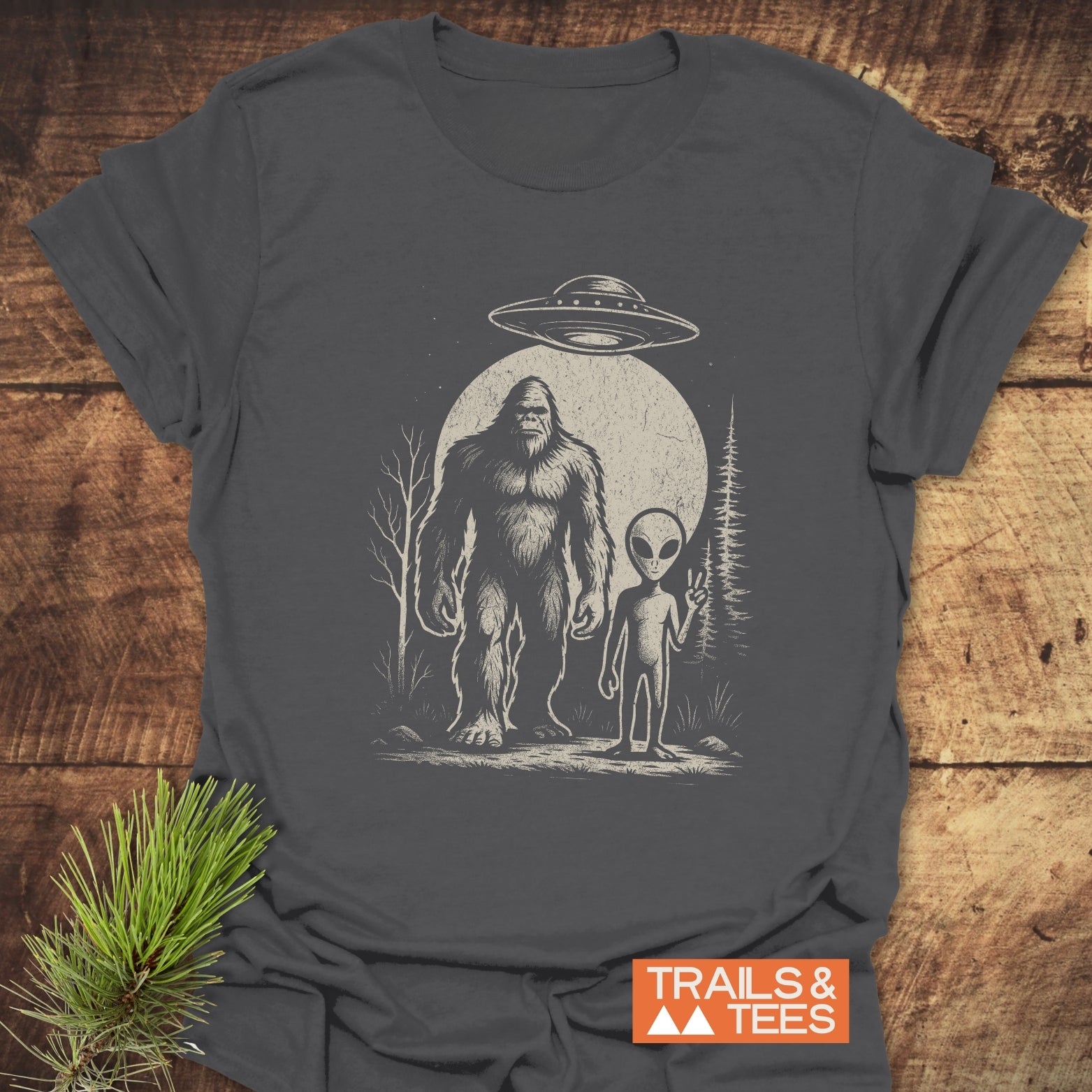 Bigfoot And Alien T-Shirt featuring a UFO and alien drawing, crafted from soft ring-spun cotton, pre-shrunk for fit, with durable prints and no side seams.