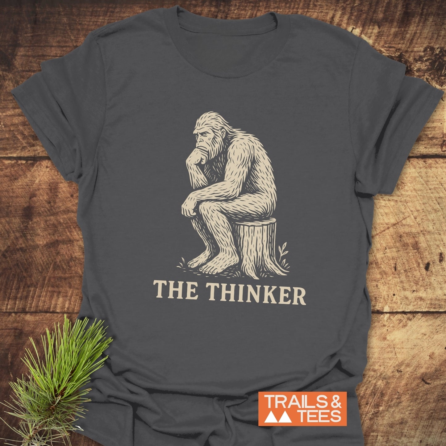 Bigfoot The Thinker T-Shirt featuring a gorilla sitting on a stump, made from soft, ring-spun cotton for comfort and durability.