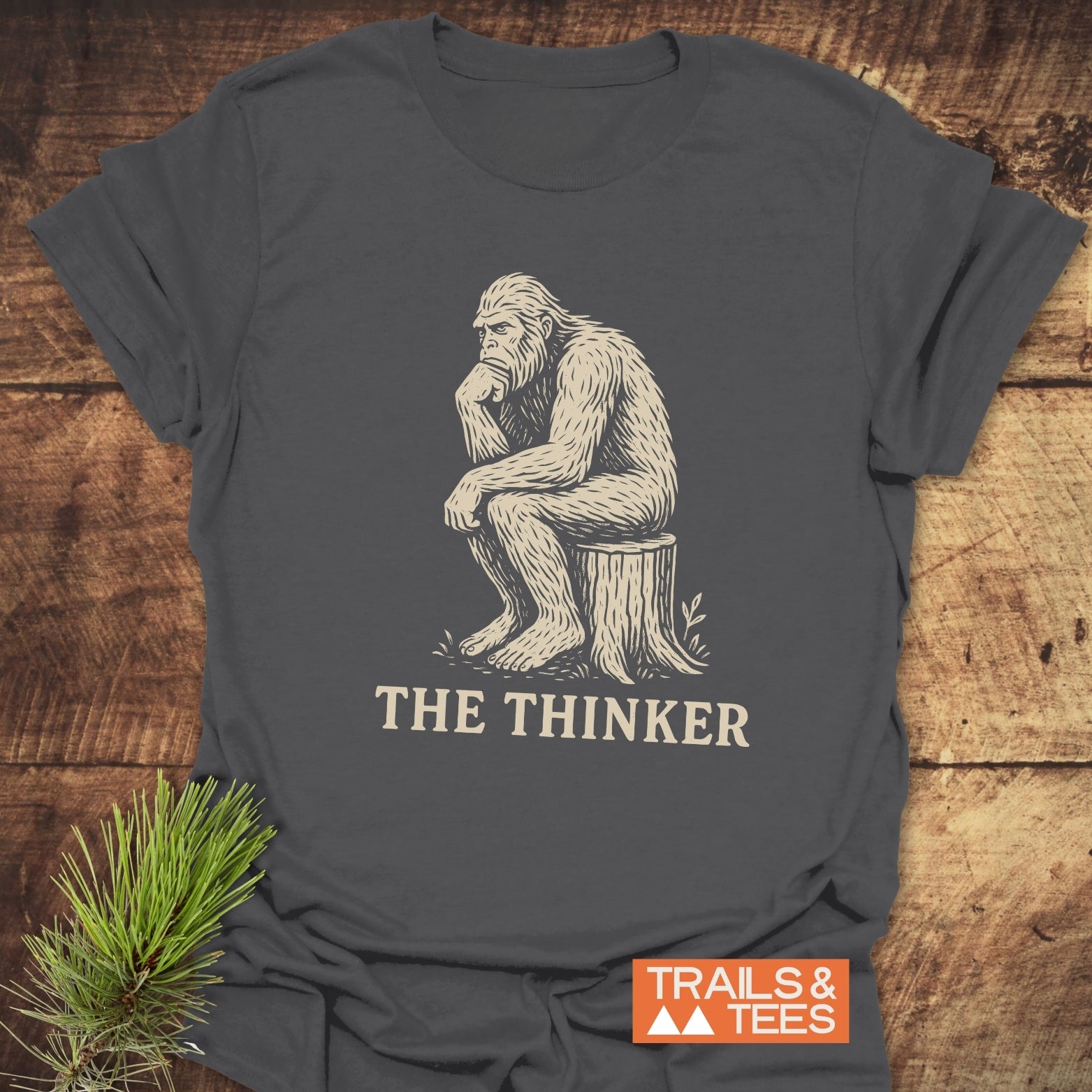 Bigfoot The Thinker T-Shirt featuring a gorilla sitting on a stump, made from soft, ring-spun cotton for comfort and durability.