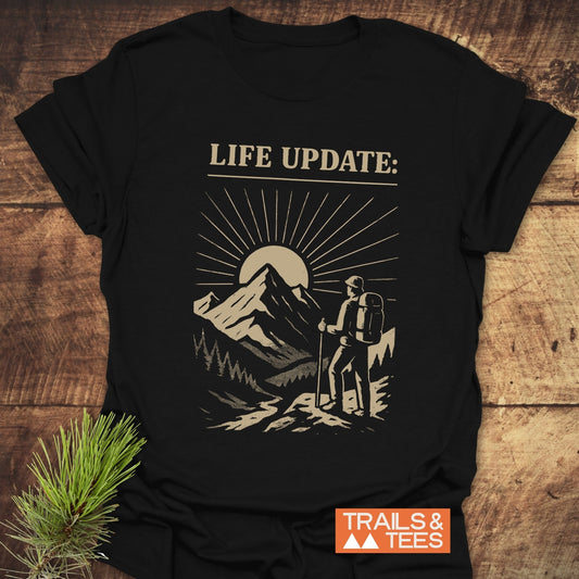 Life Update Guy T-Shirt featuring a person and mountain drawing, crafted from soft ring-spun cotton for outdoor adventures, with durable prints and a reliable fit.