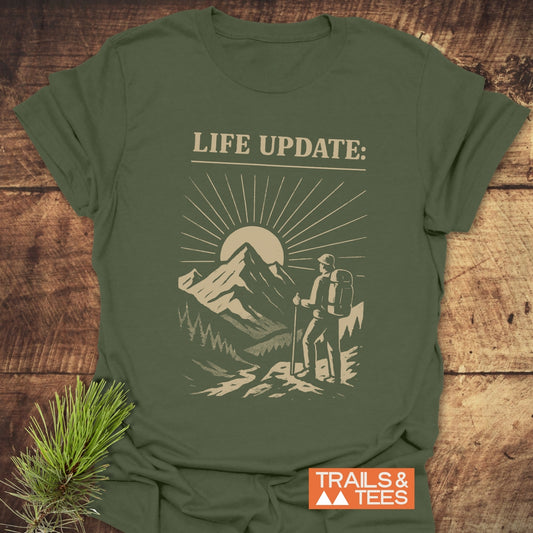 Life Update Guy T-Shirt showcasing a man hiking graphic, highlighting durable, pre-shrunk cotton design with taped shoulders and no side seams for lasting comfort.