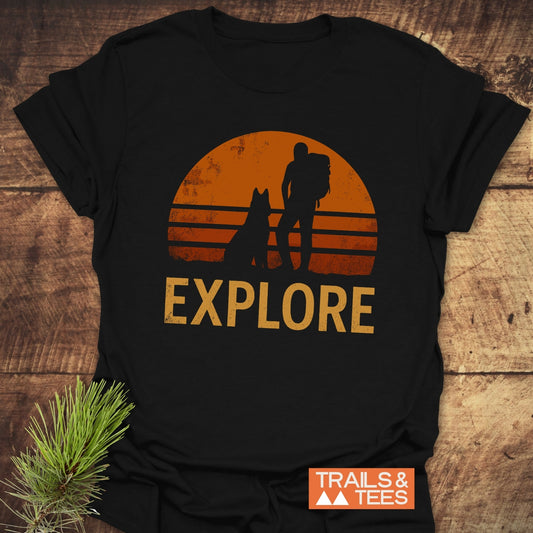 Explore Dog T-Shirt featuring silhouettes of a man and a dog, and a person with a backpack, ideal for active, outdoor enthusiasts.